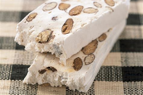 There are three main types of nougat: white, brown, and viennese. 1. White nougat, the most common variety, is likely what you're familiar with. It's made with beaten egg whites, sugar or honey, and sometimes other ingredients to add flavor and texture (such as nuts and candied fruits). 2. Brown nougat – which is … See more
